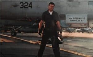 a man standing in front of a fighter jet.