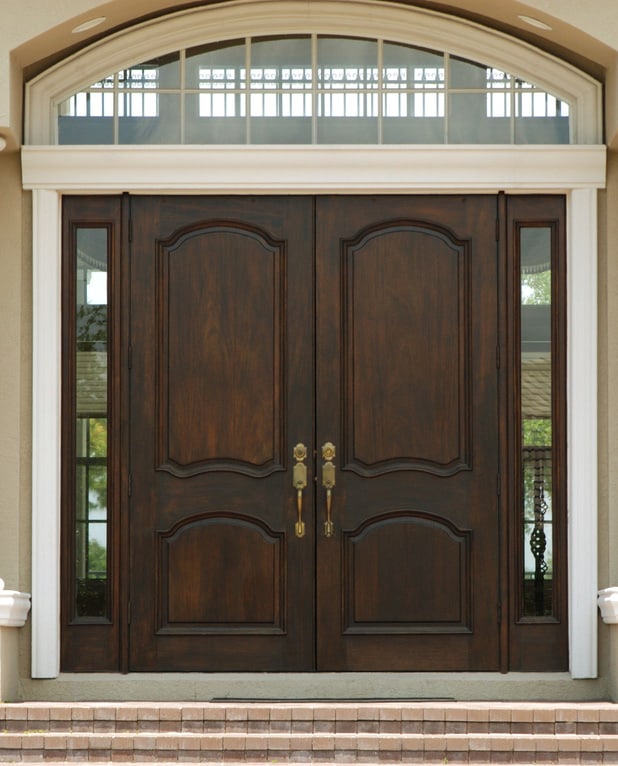 A tall door flanked by two glass panels.