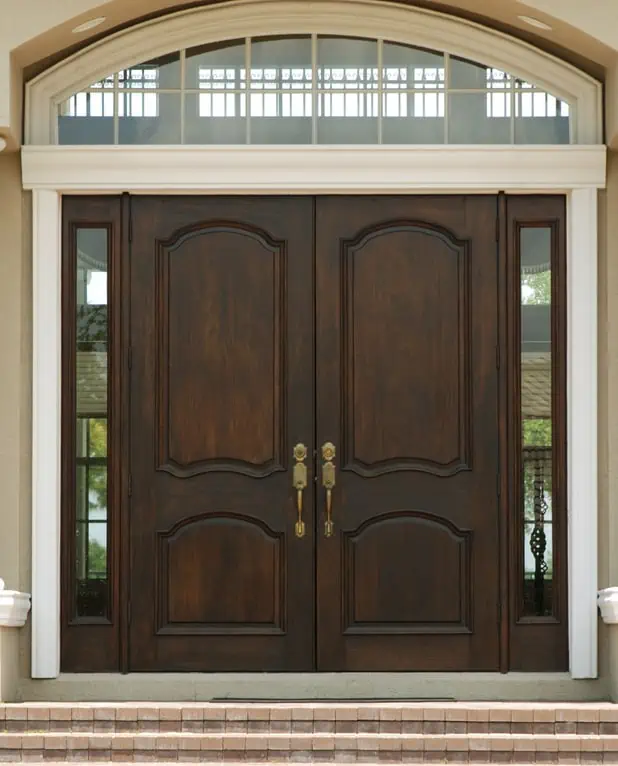 A tall door flanked by two glass panels.