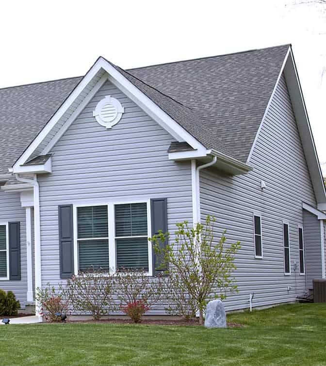 a clock house with white siding.