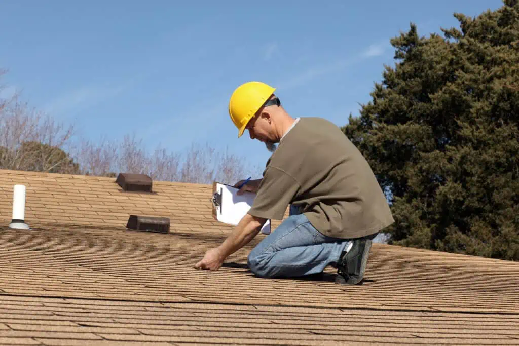a man installing a new roof replacement