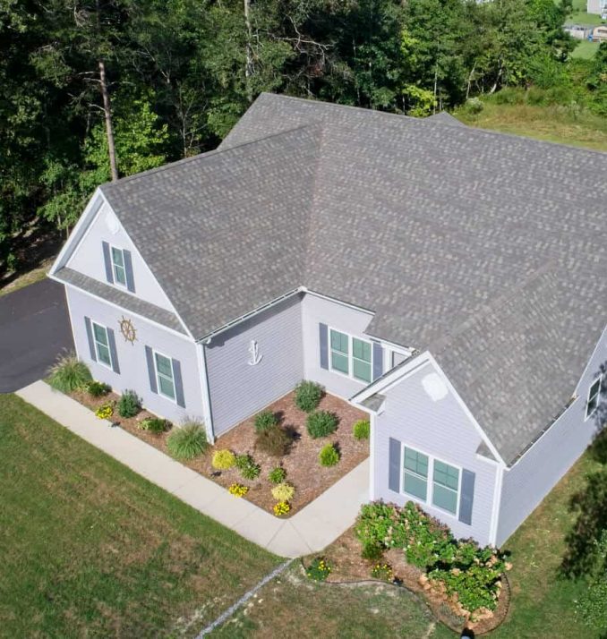 An aerial view of an asphalt shingle roof on a residential home.